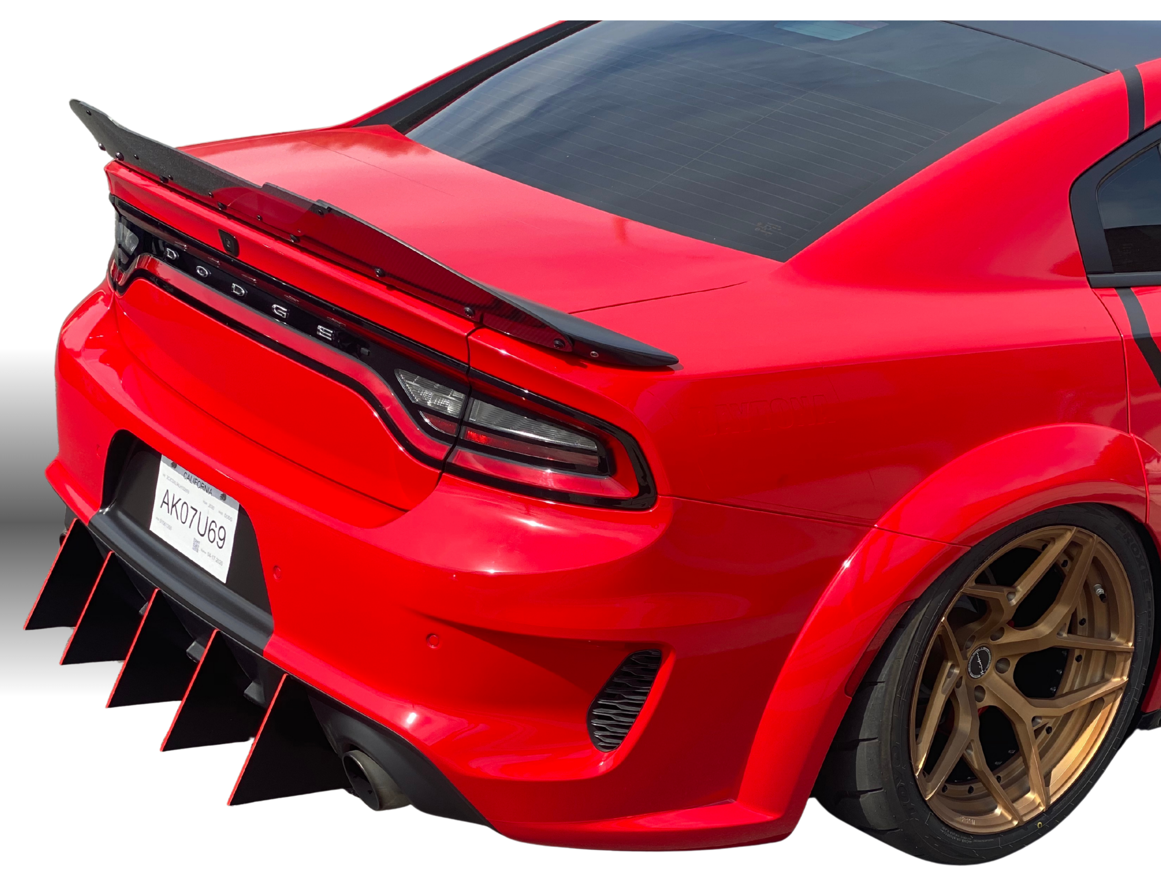 Red car with a black spoiler and gold wheels on a white background focusing on the rear diffuser add on
