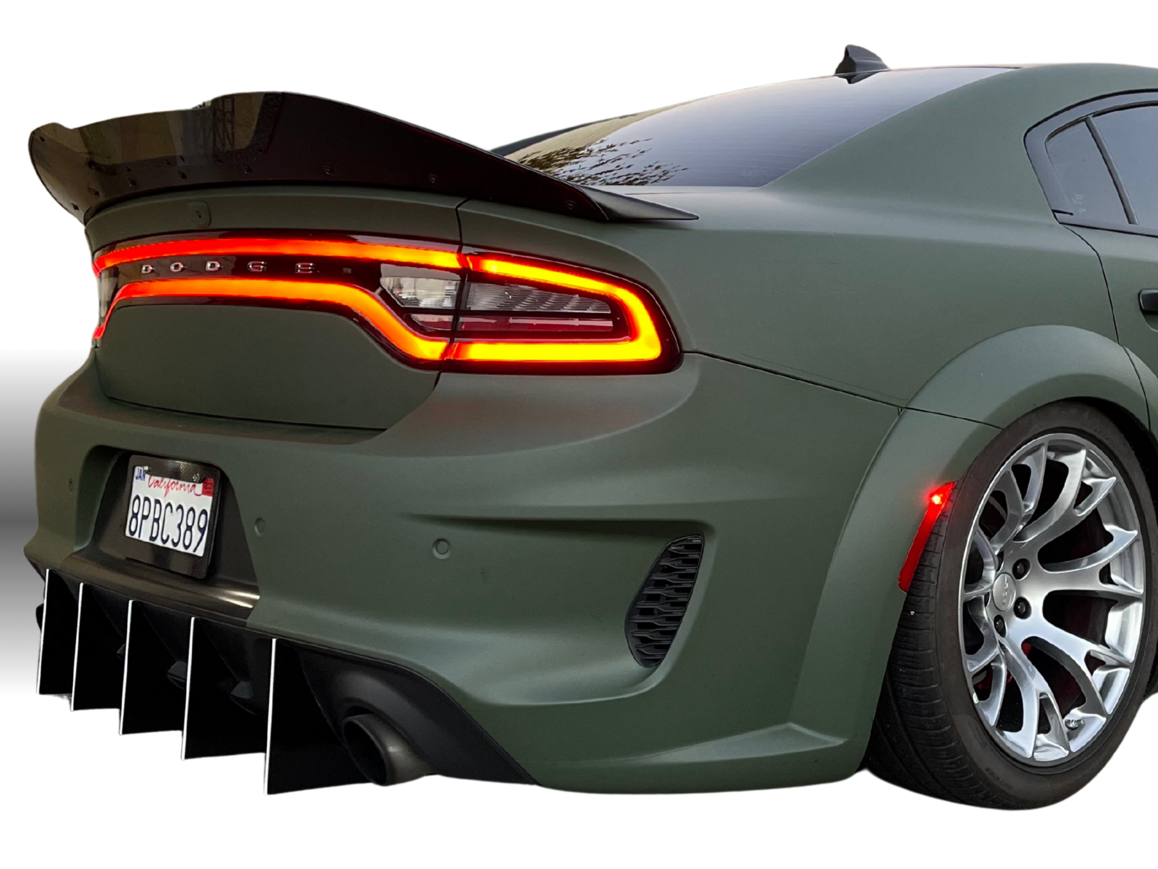 Green Dodge car with a focus on the rear design diffuser on a white background